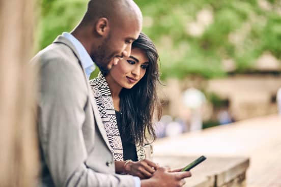 Man and woman looking at phone