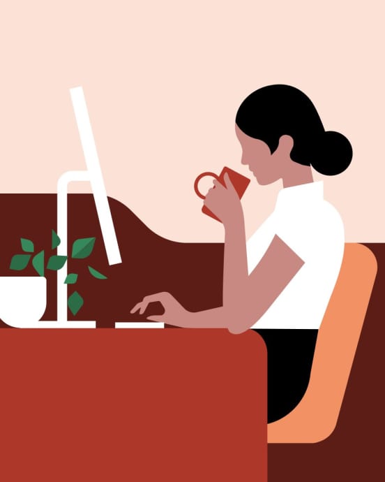  Admin on her desktop computer sipping tea
