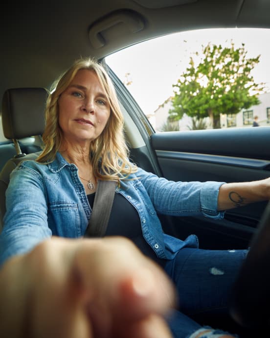 Woman pointing to the camera simulating to touch a screen