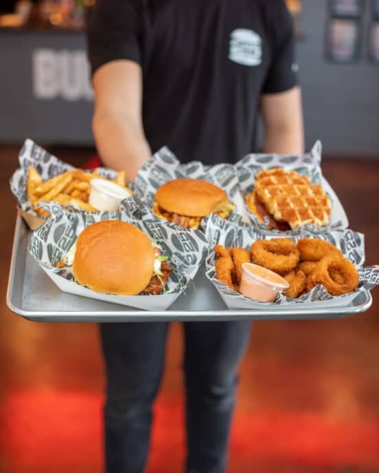 Server holding burgers