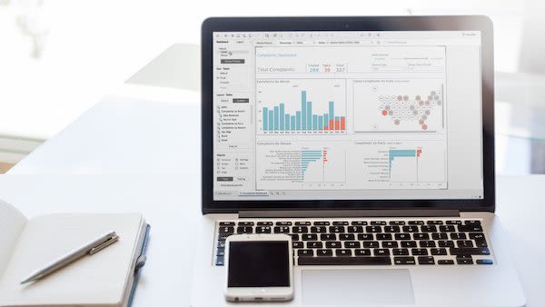 A laptop showing a dashboard from the data visualization tool Tableau